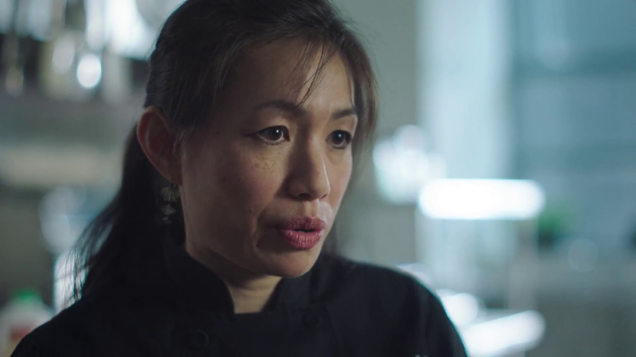 Woman in a black chef robe